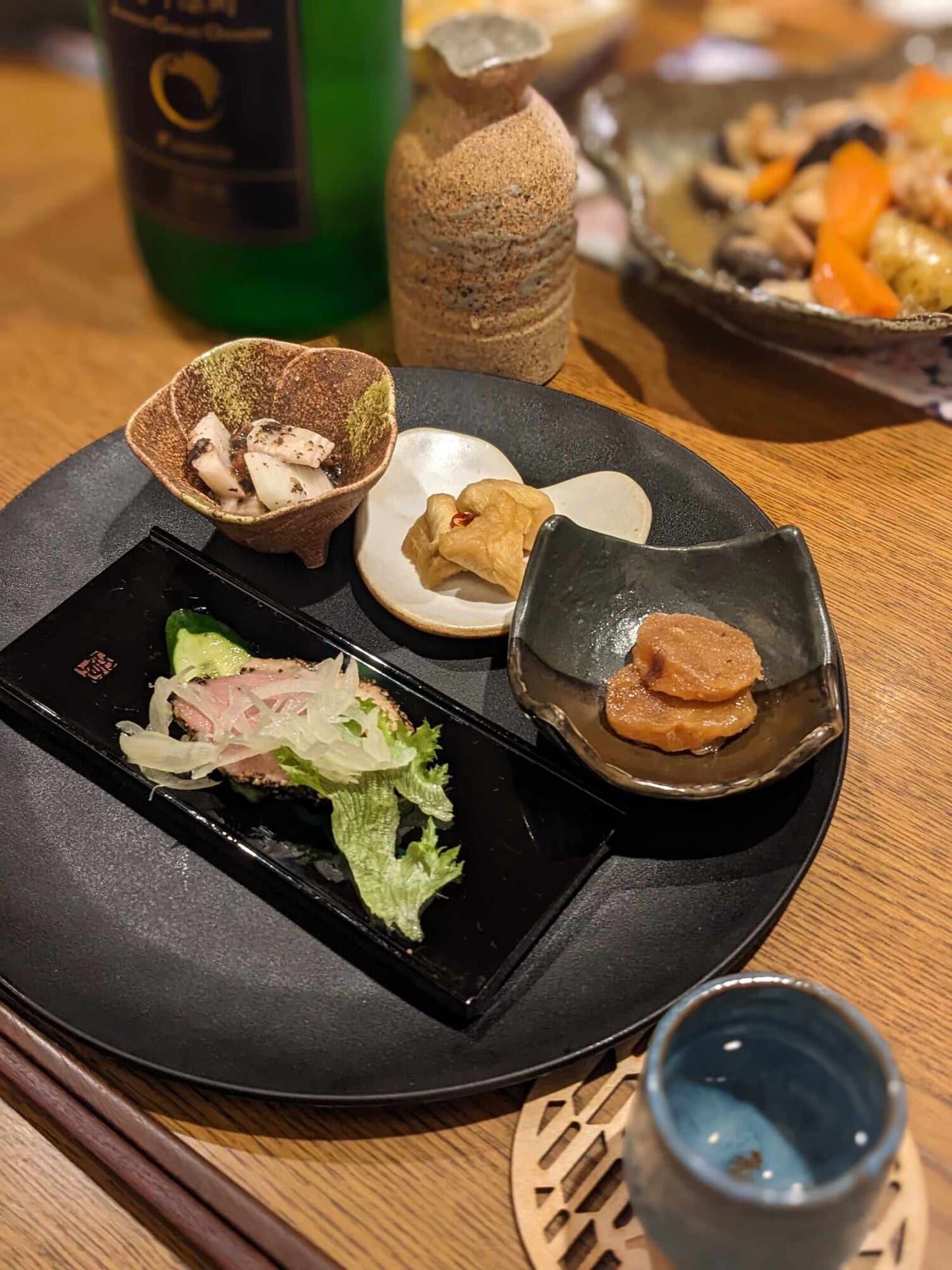 An assortment of home-style obanzai dishes with sake
