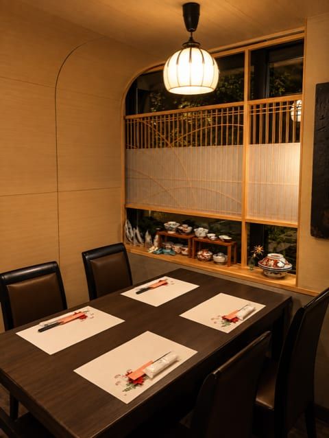 A private dining room lit by a washi paper lantern